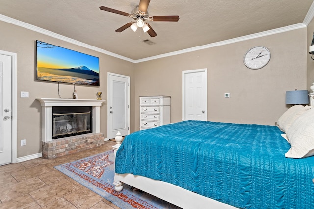 bedroom with crown molding, a fireplace, baseboards, a textured ceiling, and a ceiling fan