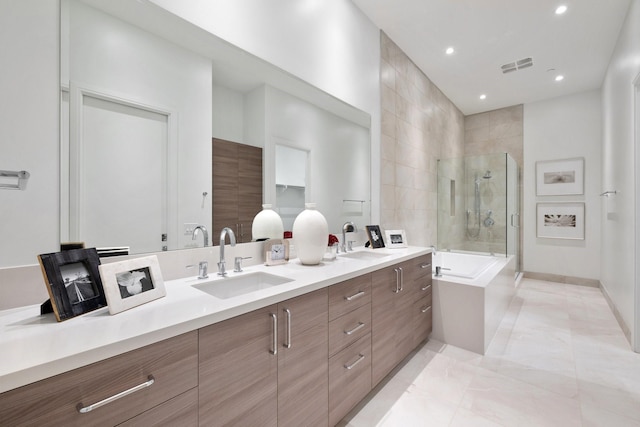 2323 W Main St Unit 703, Houston, TX 77098 - bathroom with a sink, a washtub, a tile shower, and visible vents