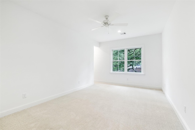 spare room featuring ceiling fan, visible vents, light colored carpet, baseboards, and recessed lighting