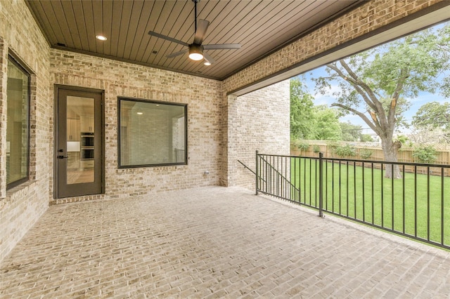 view of patio featuring fence and a ceiling fan