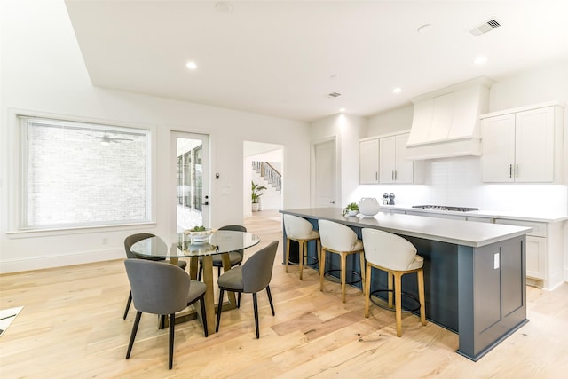 kitchen with a center island, light wood-type flooring, gas stovetop, and visible vents