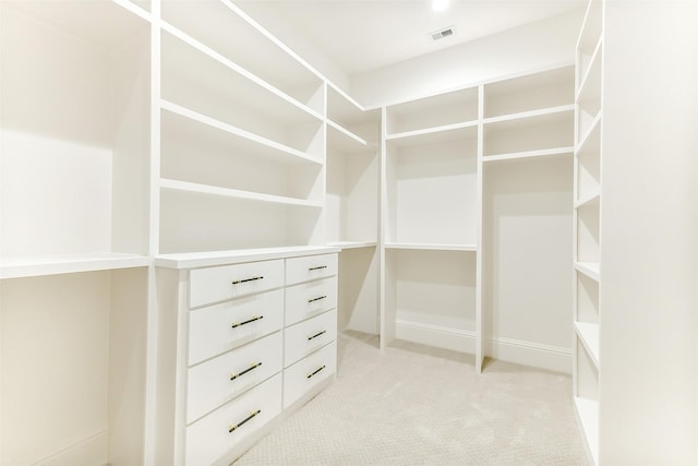 walk in closet featuring light colored carpet and visible vents