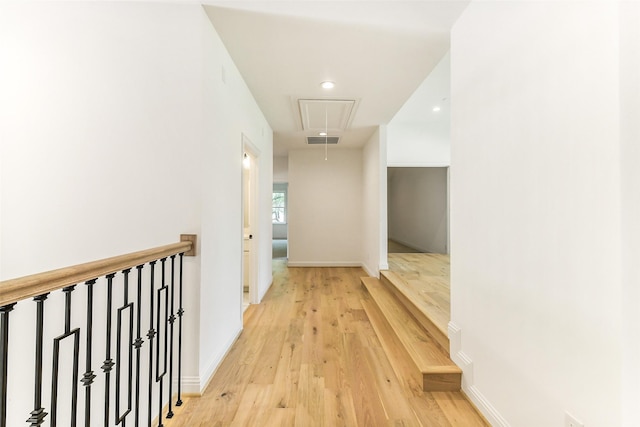 corridor with attic access, recessed lighting, baseboards, light wood-type flooring, and visible vents