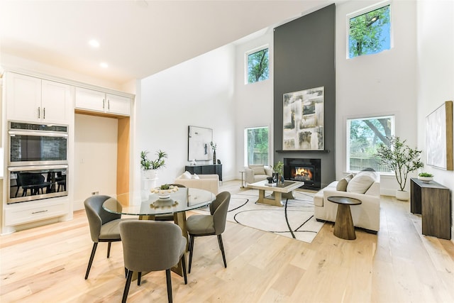 dining area featuring a wealth of natural light and a towering ceiling