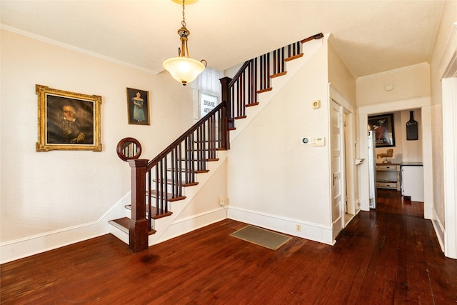 stairs featuring wood-type flooring, baseboards, and ornamental molding