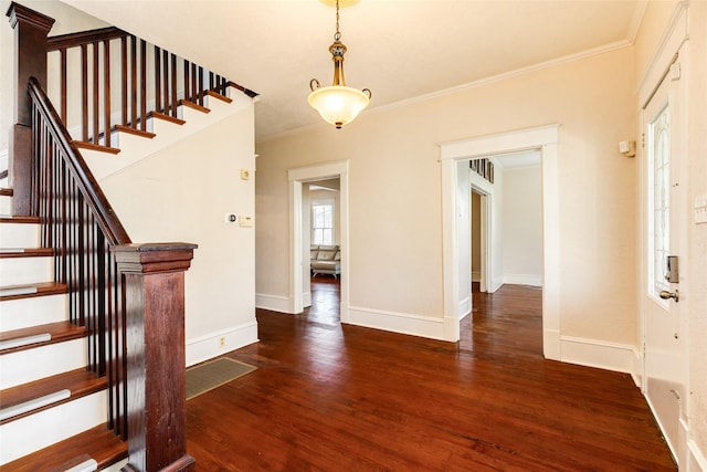 entrance foyer featuring crown molding, wood finished floors, and stairway