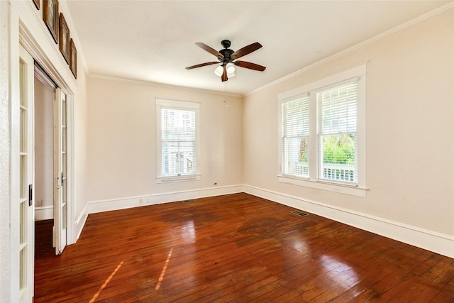 unfurnished room with crown molding, baseboards, a ceiling fan, and hardwood / wood-style flooring