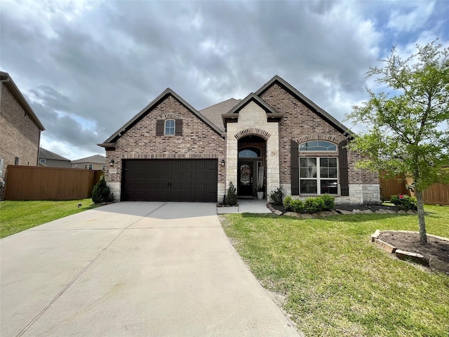 12813 Narrow Cove Dr, Texas City, TX 77568 - french country inspired facade with brick siding, concrete driveway, stone siding, and a garage