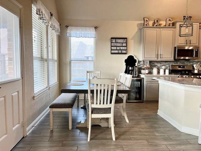 12813 Narrow Cove Dr, Texas City, TX 77568 - dining area featuring plenty of natural light, light wood-style floors, baseboards, and beverage cooler