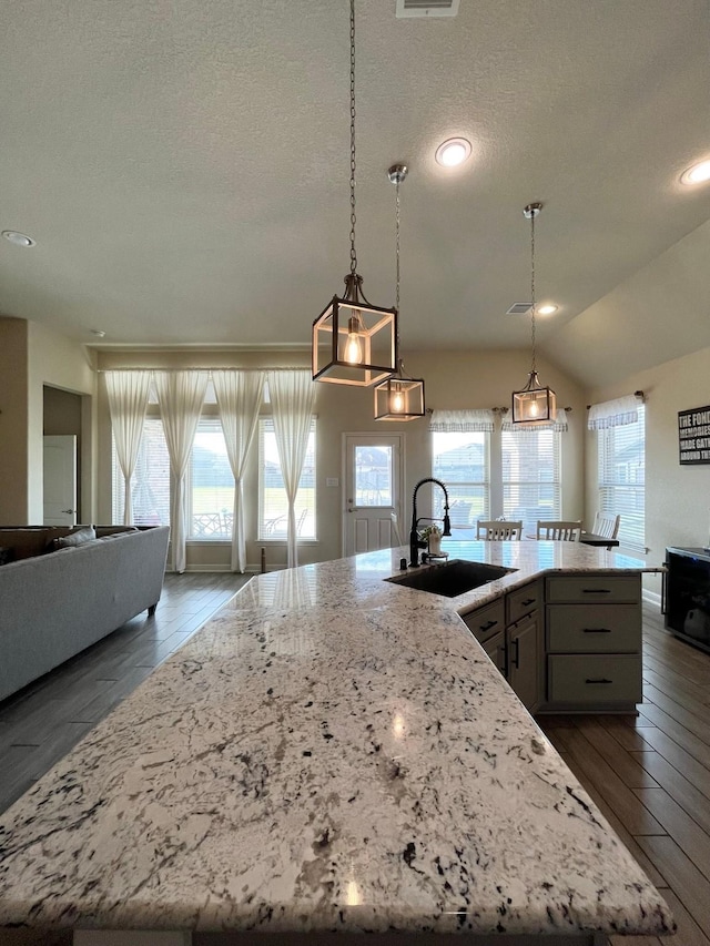 12813 Narrow Cove Dr, Texas City, TX 77568 - kitchen featuring a sink, light stone counters, plenty of natural light, a textured ceiling, and recessed lighting