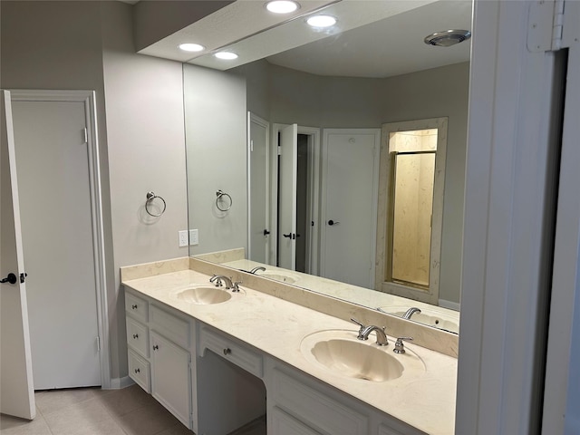 full bathroom featuring double vanity, tile patterned floors, recessed lighting, and a sink
