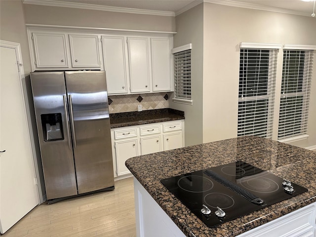 kitchen with stainless steel fridge, black electric stovetop, light wood finished floors, backsplash, and ornamental molding