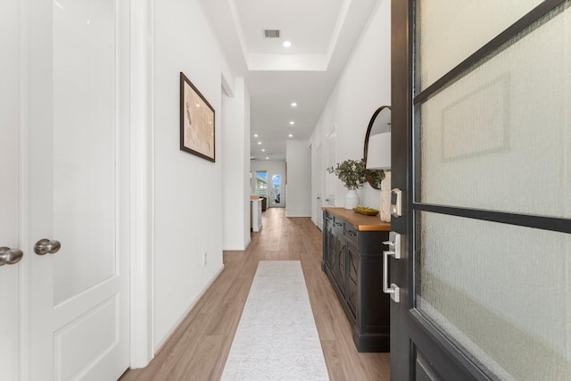 corridor with recessed lighting, visible vents, and light wood-type flooring
