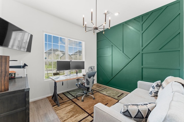 office area featuring light wood-style flooring and a chandelier
