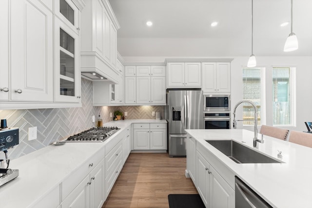 kitchen featuring a sink, white cabinets, stainless steel appliances, and tasteful backsplash