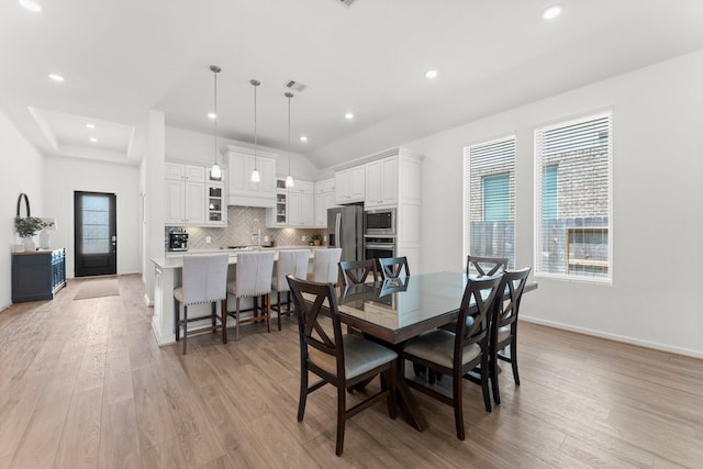 dining area with baseboards, recessed lighting, and light wood-style flooring