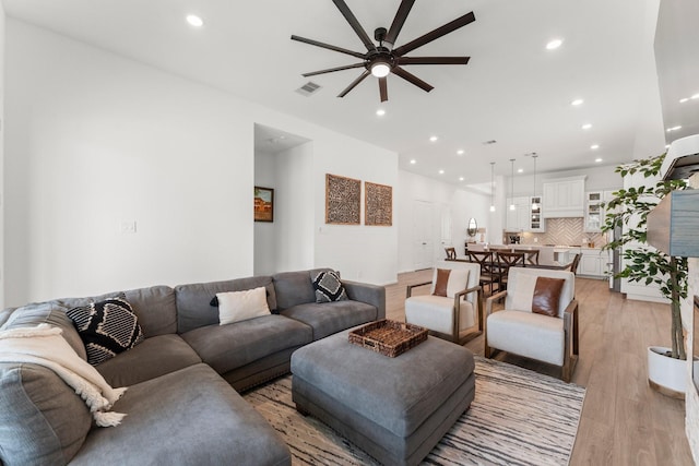 living room featuring light wood-style floors, ceiling fan, recessed lighting, and visible vents