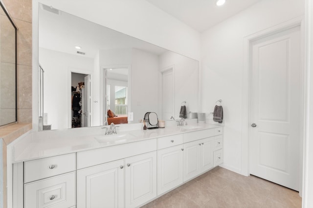 bathroom featuring double vanity, tile patterned flooring, a sink, and visible vents