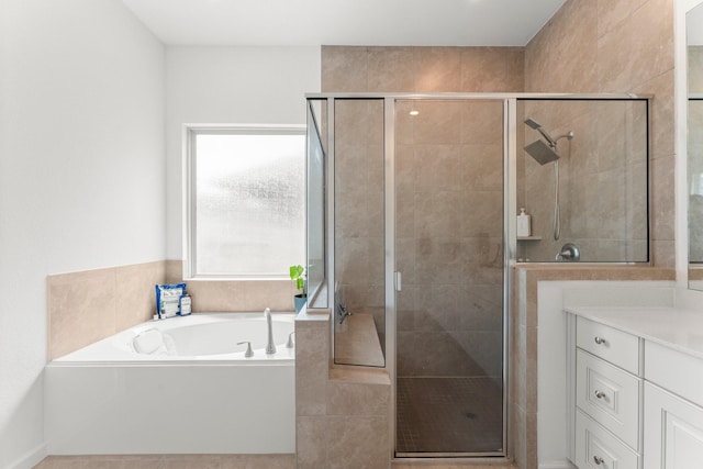 full bath with vanity, a stall shower, and a garden tub