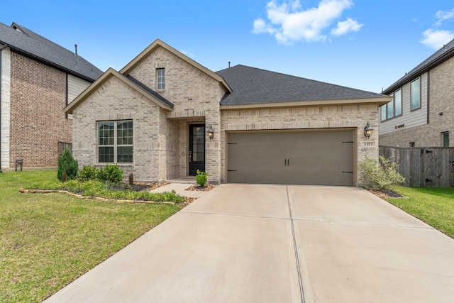 french country home with a front yard, brick siding, fence, concrete driveway, and an attached garage