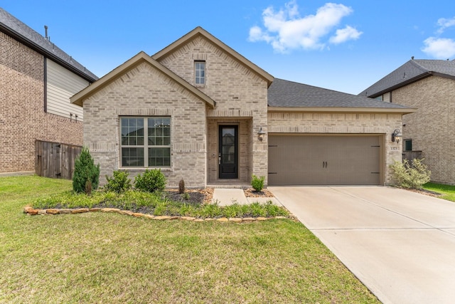 view of front of property featuring a front yard, a garage, brick siding, fence, and concrete driveway
