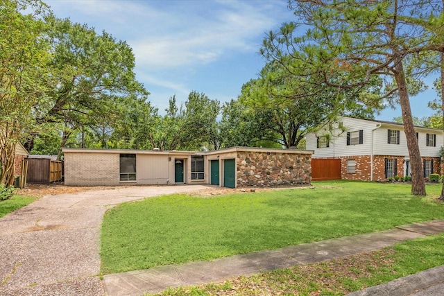 exterior space with a yard, brick siding, and fence