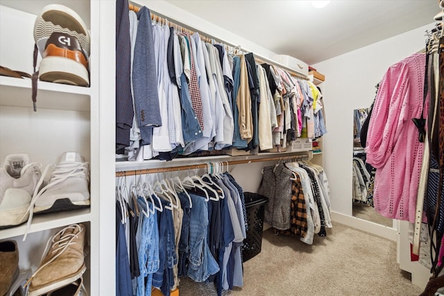 walk in closet with carpet