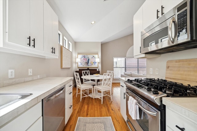 kitchen with plenty of natural light, light countertops, light wood-style flooring, and stainless steel appliances