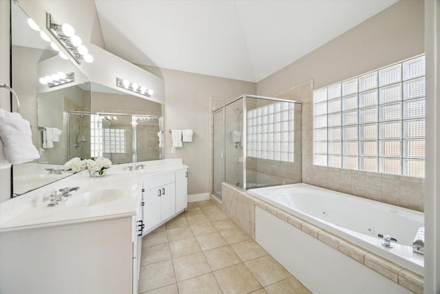 bathroom featuring a whirlpool tub, a sink, tile patterned flooring, and a stall shower