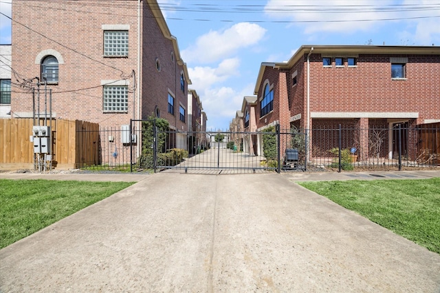 view of road featuring a gate, a gated entry, and concrete driveway