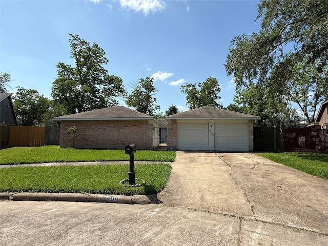 710 Fawnwood Dr, Missouri City, TX 77489 - ranch-style home with fence, brick siding, a garage, a front yard, and concrete driveway