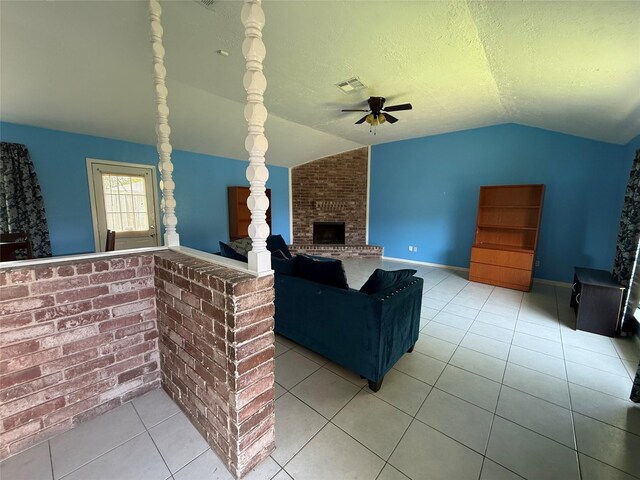 710 Fawnwood Dr, Missouri City, TX 77489 - tiled living room featuring a ceiling fan, a textured ceiling, visible vents, a brick fireplace, and lofted ceiling
