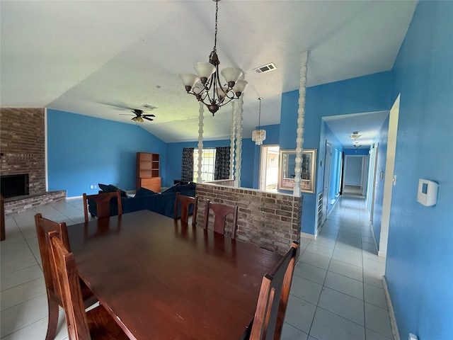 710 Fawnwood Dr, Missouri City, TX 77489 - tiled dining area featuring visible vents, a fireplace, baseboards, ceiling fan with notable chandelier, and lofted ceiling
