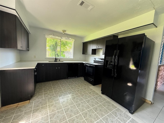 710 Fawnwood Dr, Missouri City, TX 77489 - kitchen with light countertops, light tile patterned floors, black appliances, and a sink