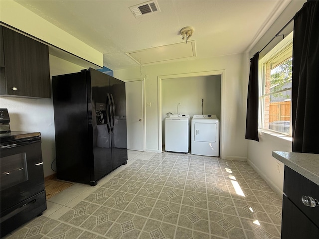 710 Fawnwood Dr, Missouri City, TX 77489 - kitchen featuring light tile patterned floors, black appliances, washing machine and dryer, and visible vents