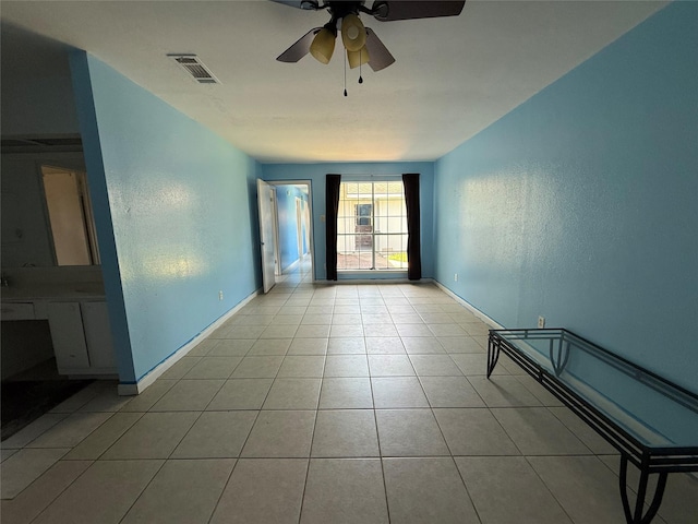 710 Fawnwood Dr, Missouri City, TX 77489 - tiled spare room with baseboards, a textured wall, a ceiling fan, and visible vents