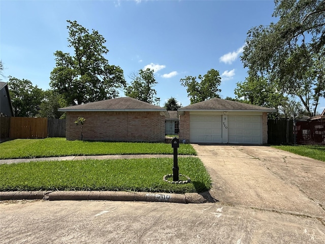 710 Fawnwood Dr, Missouri City, TX 77489 - ranch-style home with fence, a detached garage, a front lawn, and brick siding