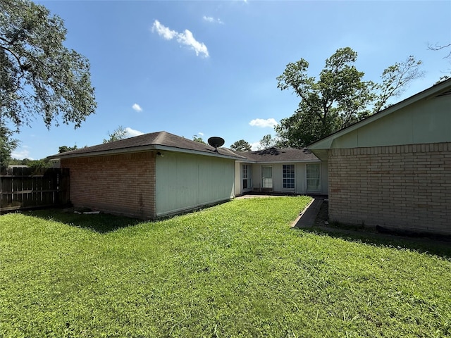 710 Fawnwood Dr, Missouri City, TX 77489 - exterior space featuring fence, a lawn, and brick siding