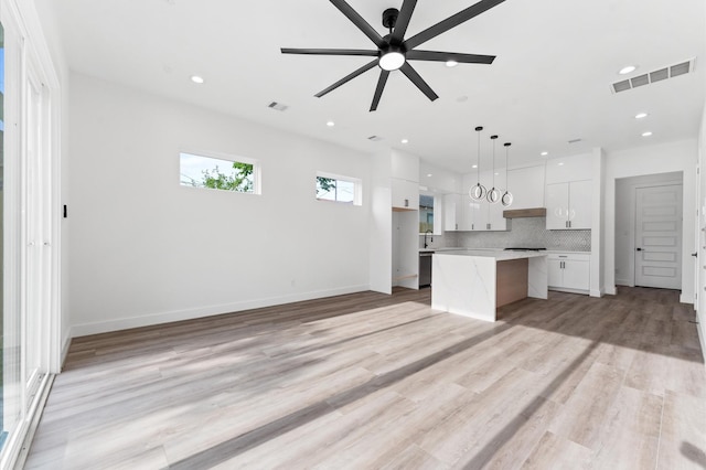 kitchen featuring light countertops, ceiling fan, white cabinetry, and visible vents