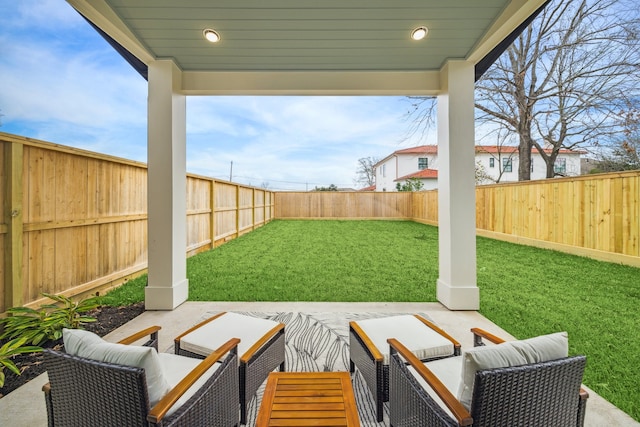 exterior space with a patio, a fenced backyard, and an outdoor hangout area