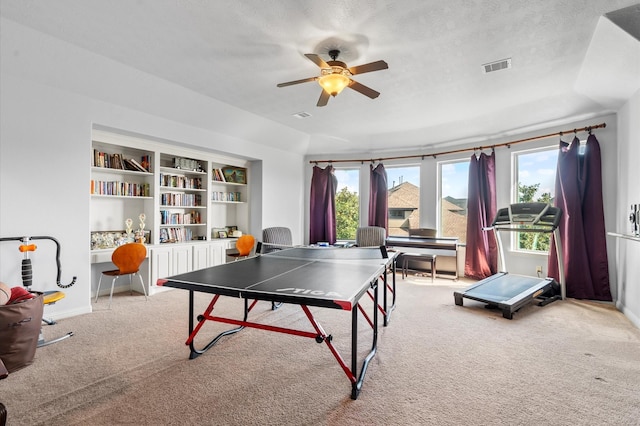 rec room featuring carpet floors, ceiling fan, a wealth of natural light, and visible vents