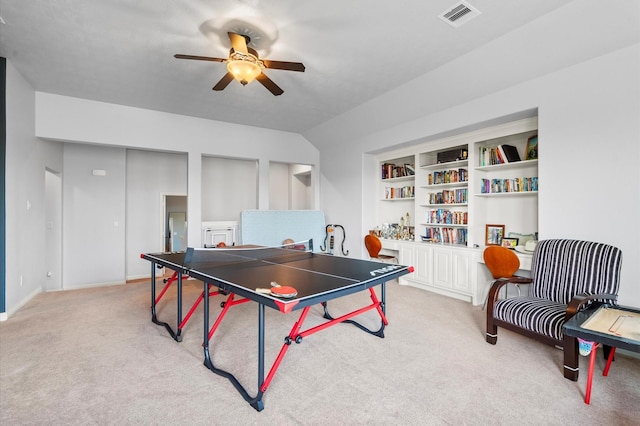 rec room featuring visible vents, built in features, ceiling fan, and light colored carpet