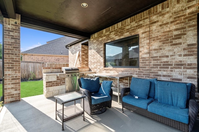 view of patio featuring fence, an outdoor hangout area, and grilling area