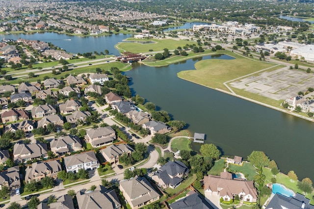 birds eye view of property with a water view and a residential view