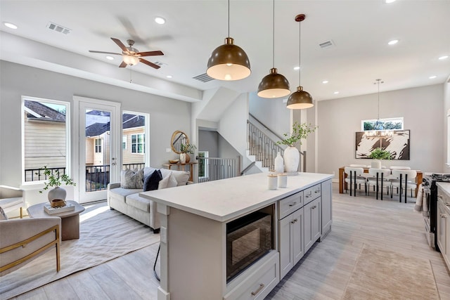 kitchen featuring recessed lighting, open floor plan, and black microwave
