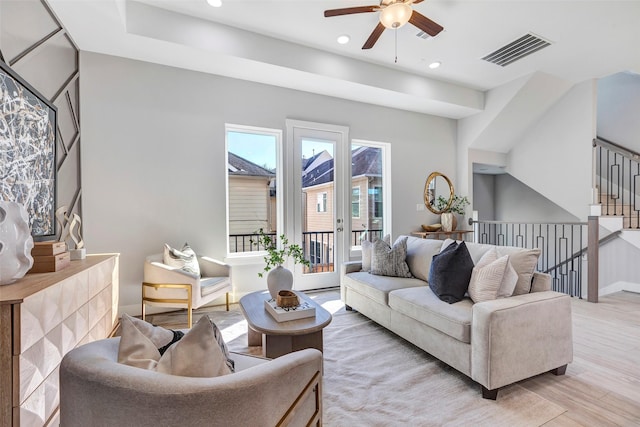 living room featuring recessed lighting, ceiling fan, visible vents, and light wood finished floors