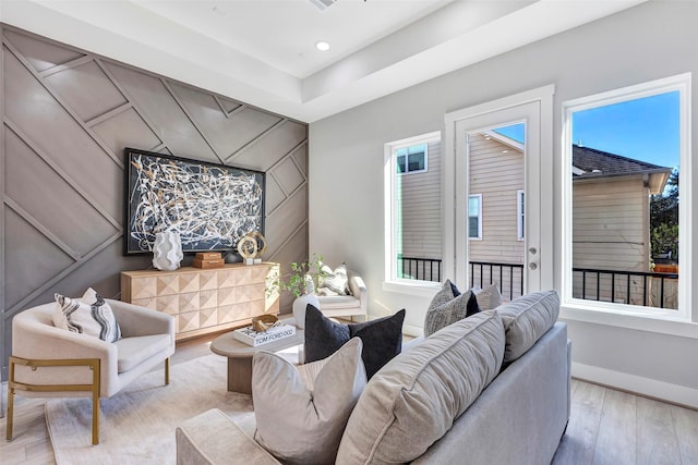 living room with recessed lighting, baseboards, and wood finished floors