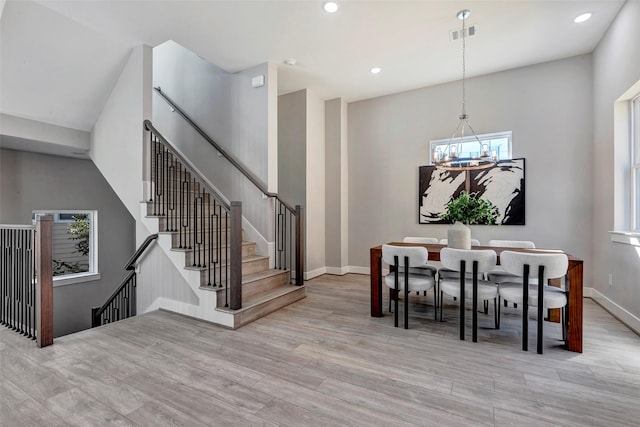 dining room featuring baseboards, an inviting chandelier, visible vents, and light wood-style floors