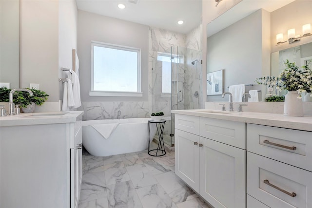 full bath featuring a sink, a marble finish shower, a freestanding tub, and marble finish floor