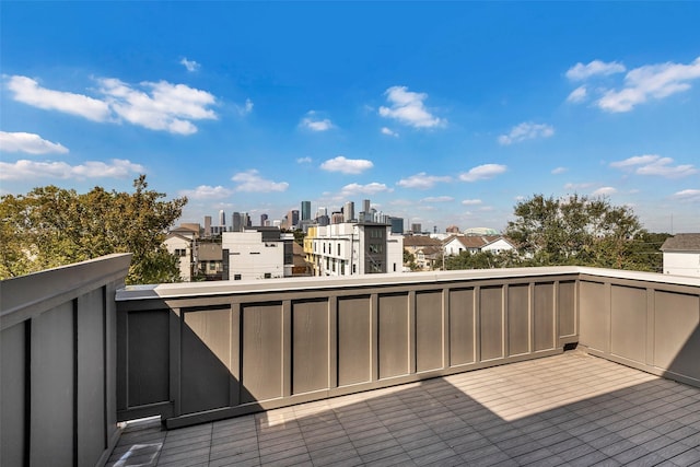 wooden terrace featuring a city view